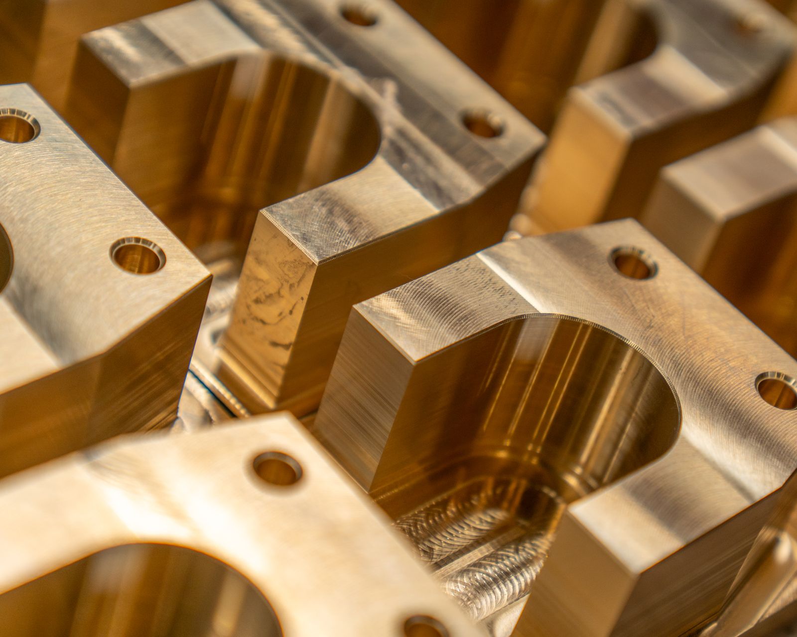 Rows of precision-machined brass component housings after CNC milling